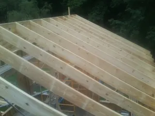 New roof rafters set over an addition before sheathing in Lockeford