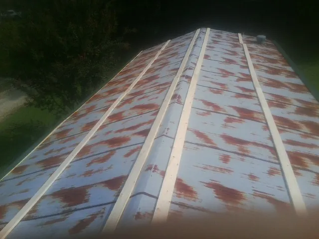 Rusted metal roof panels with new wood purlins before replacement — Storm Damage Roof Repair in Lockeford by Roofing Brothers