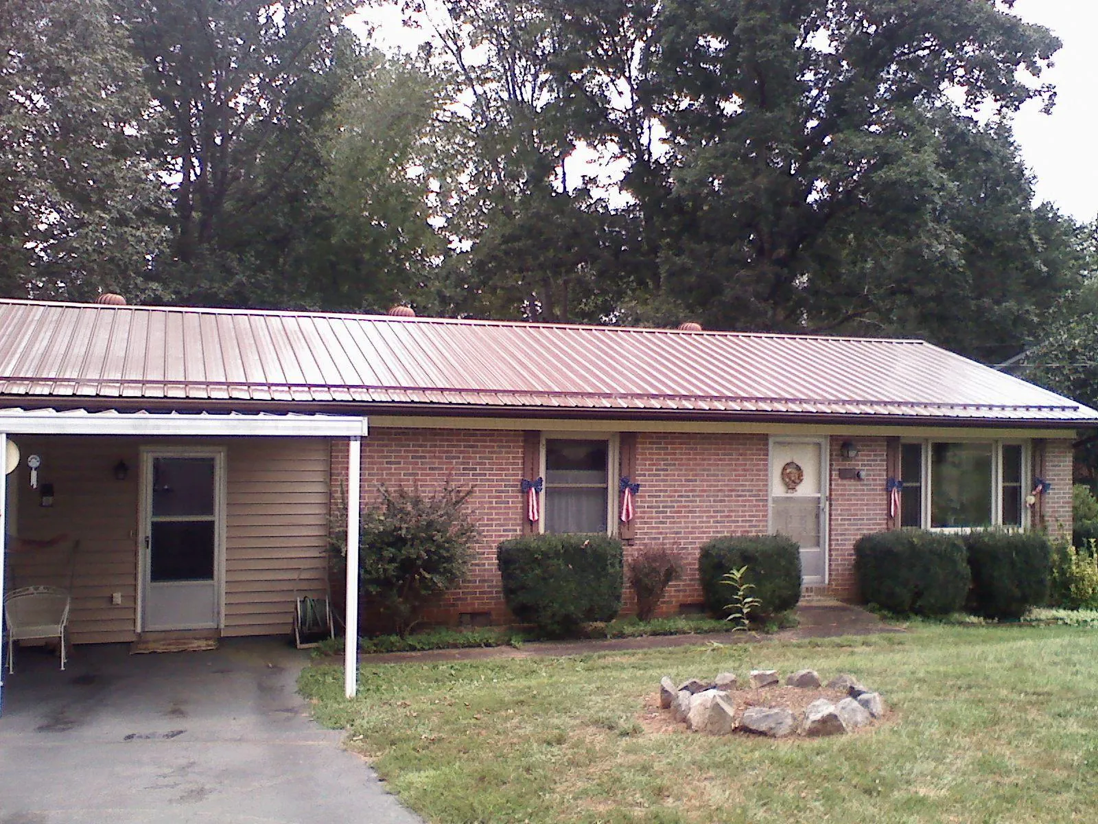 Bronze metal roof and carport on a brick ranch home — Roof Repair work by our crew in Lockeford